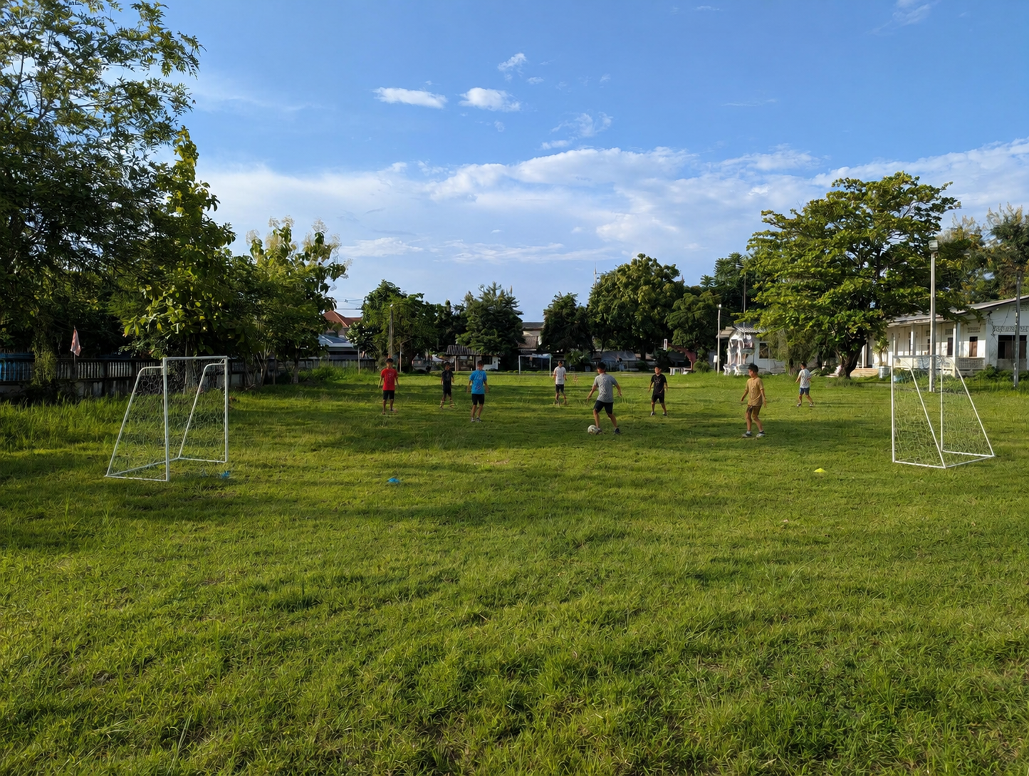 Learners playing a small-sided football match on the neighboring grass field